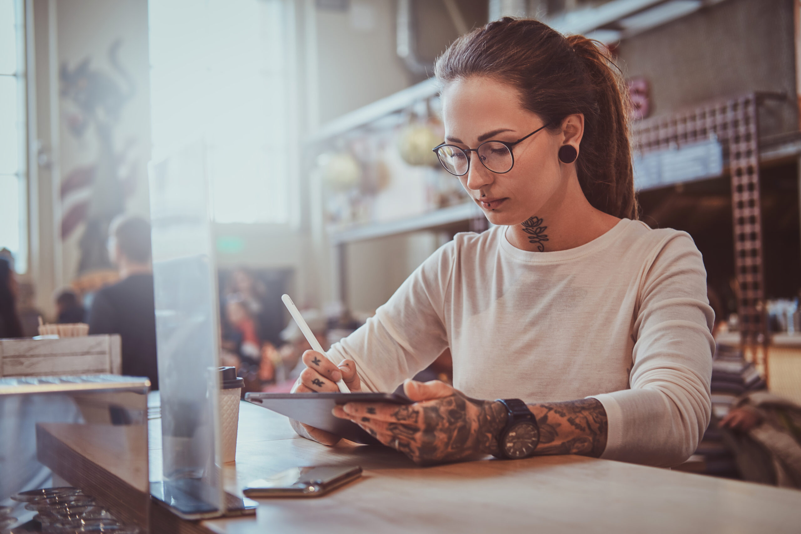 portrait of beautiful tattoed girl with sketch pad